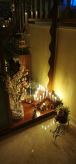Cozy Christmas Candlelit Scene with Santa Figurine and Decorations
