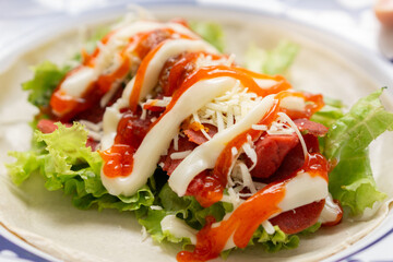 Delicious wrap with fresh lettuce, cheese, and sauces
