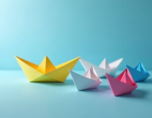 Naklejka premium Yellow paper boat leads group of different color origami ships. Colorful handmade toys sail together on blue background, symbolizing teamwork and guidance.