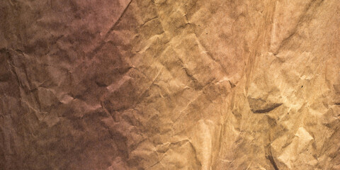 This image features a close-up texture of wrinkled brown kraft paper. The surface appears naturally rough, with visible creases, folds, and subtle color variations. The warm earthy tones create a rust