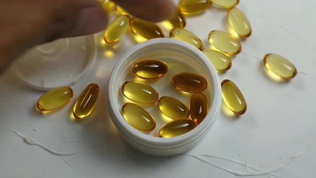 Close-Up View of Vitamin D3 Softgel Capsules  One Held in a Cap with Others
