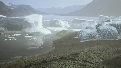 Icebergs drift calmly in a serene glacier lagoon at dawn. The soft light illuminates the icy formations, creating a peaceful and majestic landscape that captivates the viewer.