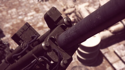 A close up view reveals the craftsmanship of a historic cannon, resting on a cobblestone surface. Surrounding elements hint at a bygone era, with stone structures nearby.