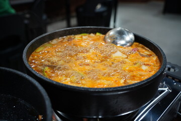 A Rich Korean Soybean Paste Stew Simmering on a Portable Stove