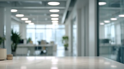 Fototapeta premium A modern office interior featuring a sleek marble table, bright lighting, and a view of workspaces in the background, promoting a professional atmosphere.