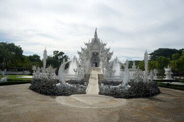 Chiang Rai, Thailand. The stucco work features intricate and exquisite Thai patterns, combined with other surreal elements of Wat Rong Khun, or the White Temple.