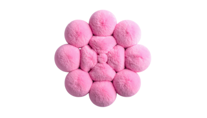 Top-down view of a flower-shaped pink furry cushion with ten puffy rounded petals on a contrasting black background