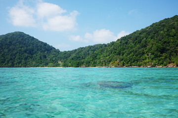 Beautiful emerald sea water and absolutely coral reef with blue sky on Surin national island of Thailand