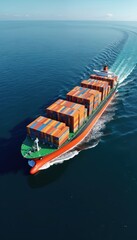 Fototapeta premium Large cargo ship travels across the vast blue ocean carrying colorful containers. Vessel moves through deep water leaving white trails. Wide expanse of sea meets clear sky.