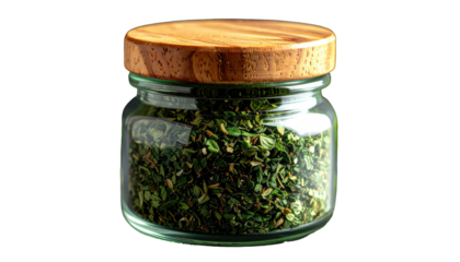 Small glass jar filled with dried green herbs and a wooden lid on a dark background, studio shot
