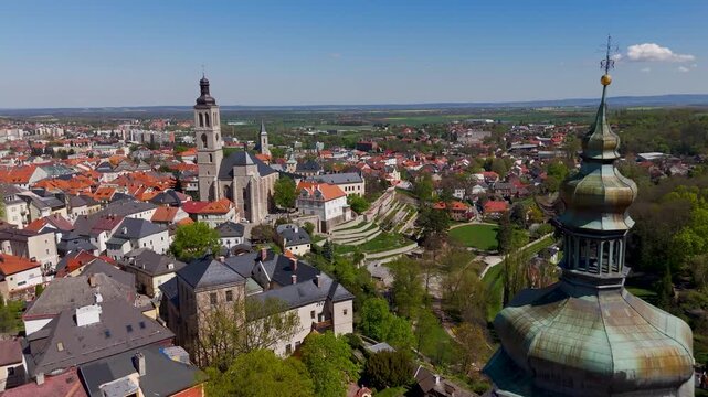 Sunny aerial drone glide over the historic Jesuit College grounds toward the Renaissance facade of the Italian Court (Vla&scaron;sk&yacute; dvůr) in Kutna Hora, Czech Republic.