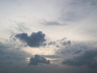 Dark, moody storm clouds are gathering in a dramatic sky with a pale, faintly lit opening near the center, suggesting impending rain or a stormy atmosphere