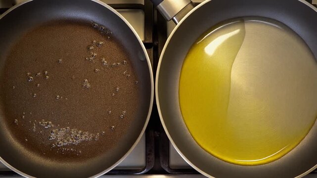 Fixed overhead frame of a cast-iron pan: right half old oil, left half new oil subtle steam on the cooked side