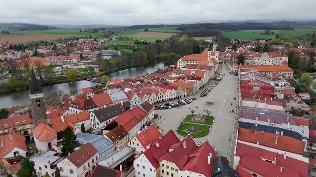 Drone wide shot over the UNESCO World Heritage town of Telč, Czech Republic, highlighting the famous vibrant Renaissance houses lining Zacharias of Hradec Square.