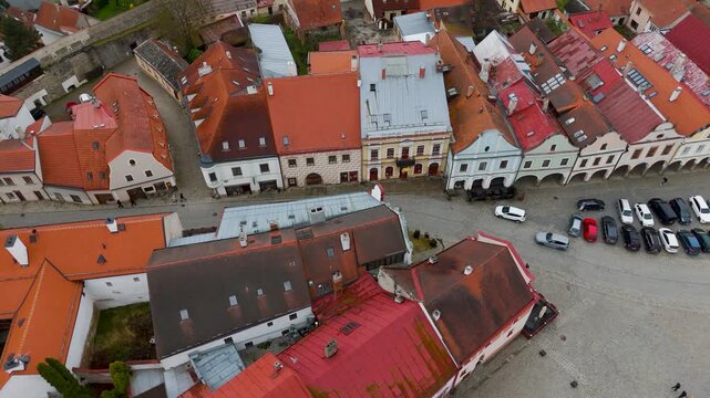 Birds eye view aerial drone shot directly over Zacharias of Hradec Square, Telč, Czech Republic, featuring the iconic rows of UNESCO World Heritage Italian Renaissance colorful houses.