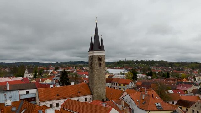 Aerial drone circle shot of the historic Church of the Holy Ghost (Kostel svat&eacute;ho Ducha) and its Gothic tower in the UNESCO World Heritage town of Telč, Czech Republic.