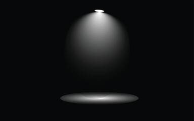 Spotlight shining down in the darkness illuminating a small area below