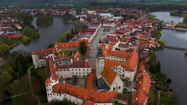 Aerial circling shot showcasing the stunning UNESCO World Heritage town of Telč, Czech Republic, famous for its perfectly preserved Italian Renaissance architecture in the Vysočina region.