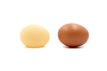 Wind egg without calcareous shell (left) and normal brown chicken egg with calcareous shell (right) isolated on a white background in side view.