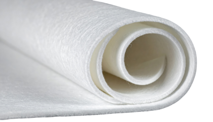 Soft, white fibrous material is partially rolled, showing interior textures against a black background