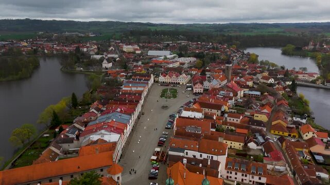 Aerial drone shot panning back from the colorful Italian Renaissance houses of Zacharias of Hradec Square in the UNESCO World Heritage town of Telč, Czech Republic.
