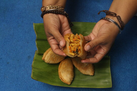 woman holding karipap