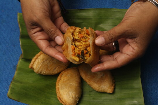 woman holding karipap