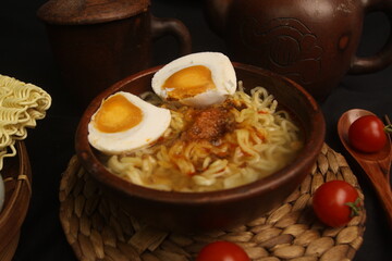 a bowl of hot boiled noodles with eggs