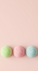 Three pastel colored ice cream scoops on a solid pink background