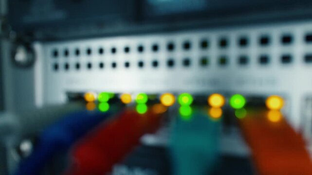 Defocused video of blinking LEDs on a network switch creating a smooth technology background suitable for corporate or IT visuals
