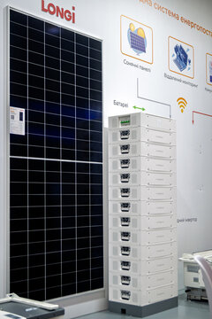 Ukraine, Kyiv - October, 16, 2025:Modern solar panel and stacked battery energy storage system by LONGi on display, illustrating renewable energy solutions.