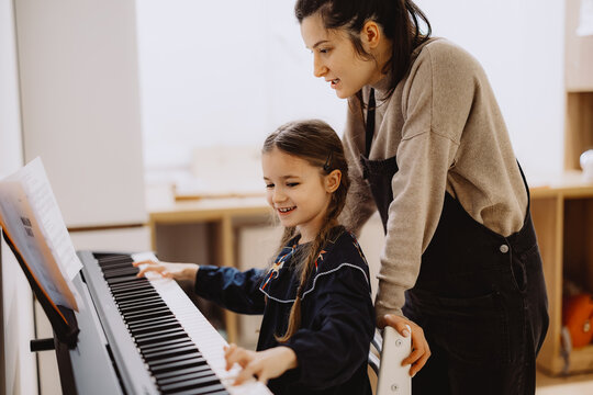 Piano Lesson with Teacher and Young Student