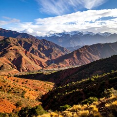 Fototapeta premium Vast landscape with layered mountains under a partly cloudy sky