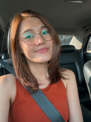 Asian Thai Young Woman Smiling Happily Inside a Car While Wearing Stylish and Trendy Sunglasses