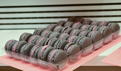 Close-up of brown macarons stacked in a row, delicate textures and pastel tones
