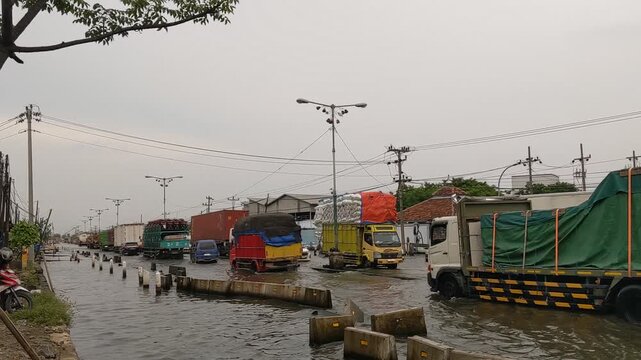 A persistent and severe flood inundates the crucial Pantura national road (Jl. Semarang-Sayung), a vital transportation artery connecting Java's northern coast. The footage, captured on 1 Nov 2025 