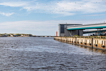 Industrial port terminal by the sea with conveyor structures and waterfront pier