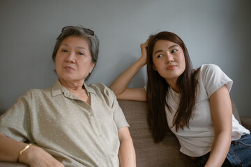 Two women< Asian Thai elderly mother and daughter, Generational Connection A Heartwarming Moment Shared Between a Grandmother and Her Granddaughter