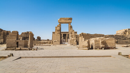 Perspective of the entrance gate of the Dendera temple, Egypt, dedicated to Hator Goddess. Paved floor in the foreground.