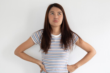 Funny boring face face of frustrated asian Thai young woman poses confidently with her hands on her hips, reflecting boredom