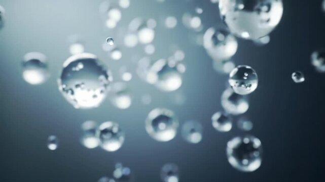 Numerous shimmering, translucent spheres of varying sizes gently ascend with a subtle upward dolly movement against a soft, ambiguous background, displaying shallow depth of field and atmospheric