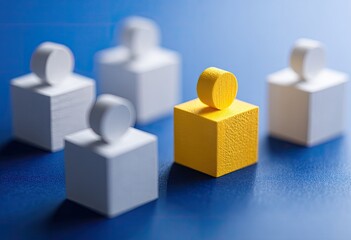 Fototapeta premium A single, bright yellow figure stands out among a group of white figures