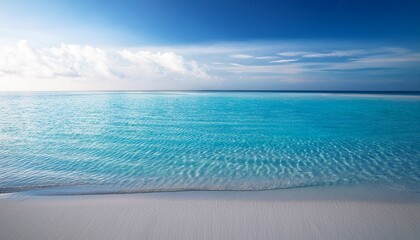 calm blue water with gentle ripples reflecting sunlight meeting smooth white sand at shore peaceful and serene scene