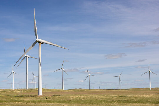 White wind turbines with blades in the steppe of Kazakhstan
