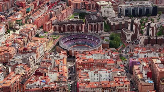 Majestic aerial view of iconic Plaza de Toros de Vista Alegre bullring, nestled amidst vibrant cityscape of Bilbao, Spain