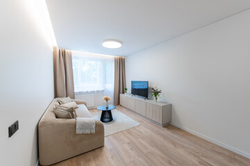 Modern Home Living Room Interior with Open TV Area and TV on the Wooden Desk, Sofa, And Coffee Table.