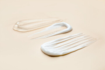 Samples of different cosmetic products on beige background, closeup