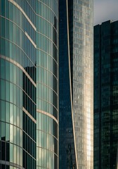 Obraz premium Contemporary urban architecture with sleek glass facade skyscrapers design