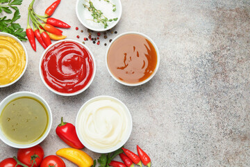 Different sauces, spices and herbs on light table, flat lay. Space for text © New Africa