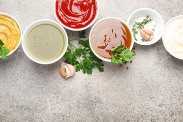 Different sauces, spices and herbs on light table, flat lay. Space for text © New Africa